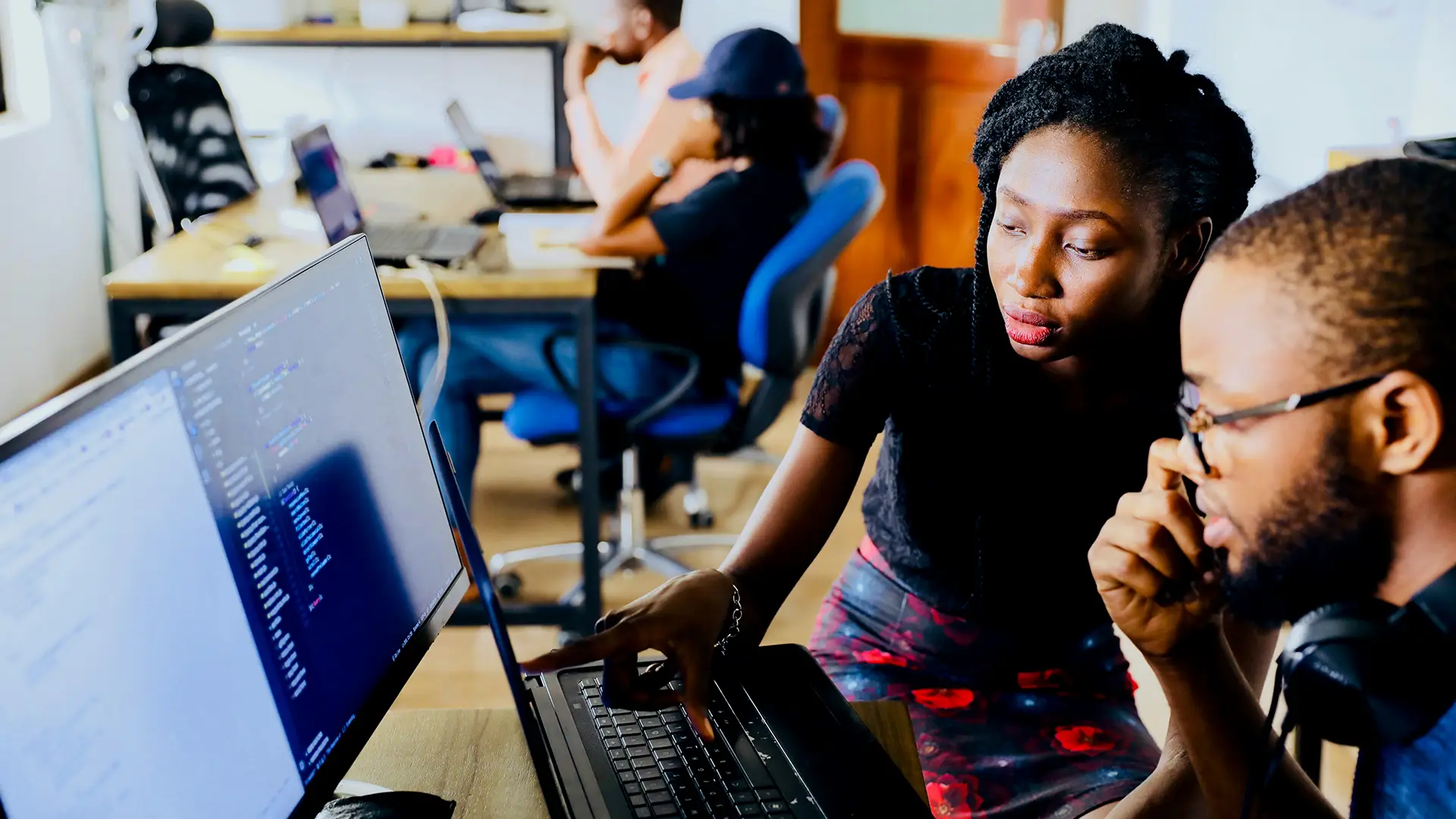 African American woman showing google ads on a computer