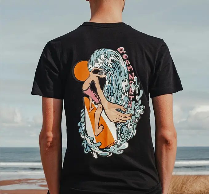 man with black t-shirt on looking at the ocean