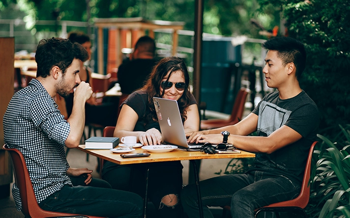 a business owner at a table talking about successful email campaigns